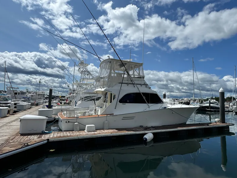 Slide: The Image of 1990 Post 44 Sport Fisherman yacht docked at marina under cloudy sky. - 3