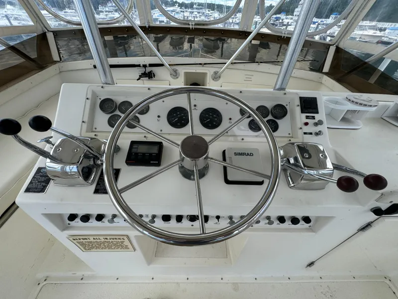 Slide: The Image of 1990 Post 44 Sport Fisherman helm with steering wheel and control panel. - 32