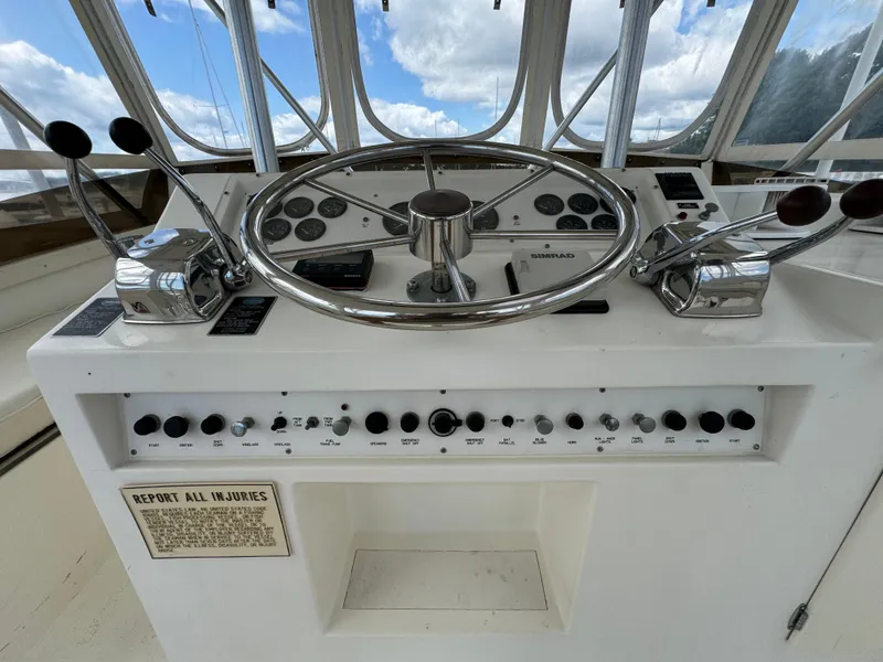 Slide: The Image of 1990 Post 44 Sport Fisherman helm with steering wheel and controls. - 33