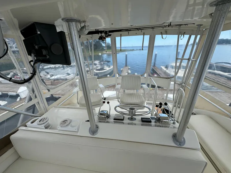 Slide: The Image of Interior of 1990 Post 44 Sport Fisherman yacht with helm and seating, overlooking marina. - 38