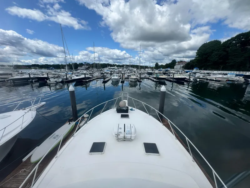 Slide: The Image of 1990 Post 44 Sport Fisherman docked at marina under cloudy sky. - 39