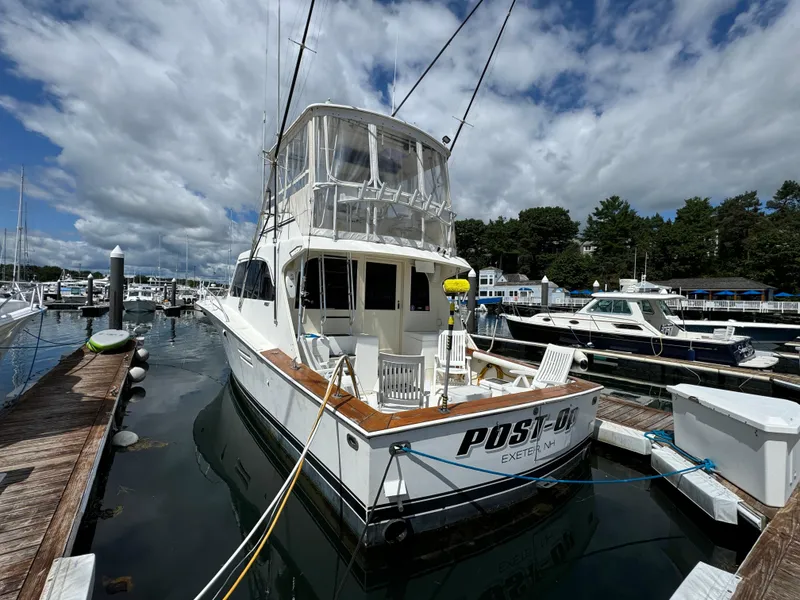 Slide: The Image of 1990 Post 44 Sport Fisherman boat docked at marina under cloudy sky. - 4