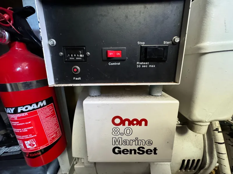 Slide: The Image of Onan 8.0 Marine GenSet control panel with fire extinguisher, 1990 Post 44 Sport Fisherman. - 42