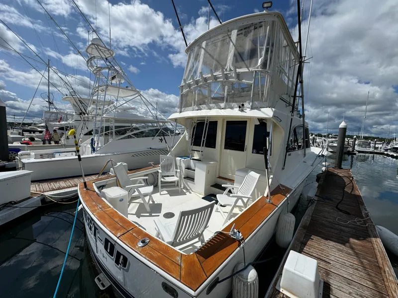 Slide: The Image of 1990 Post 44 Sport Fisherman yacht docked at marina under cloudy sky. - 5