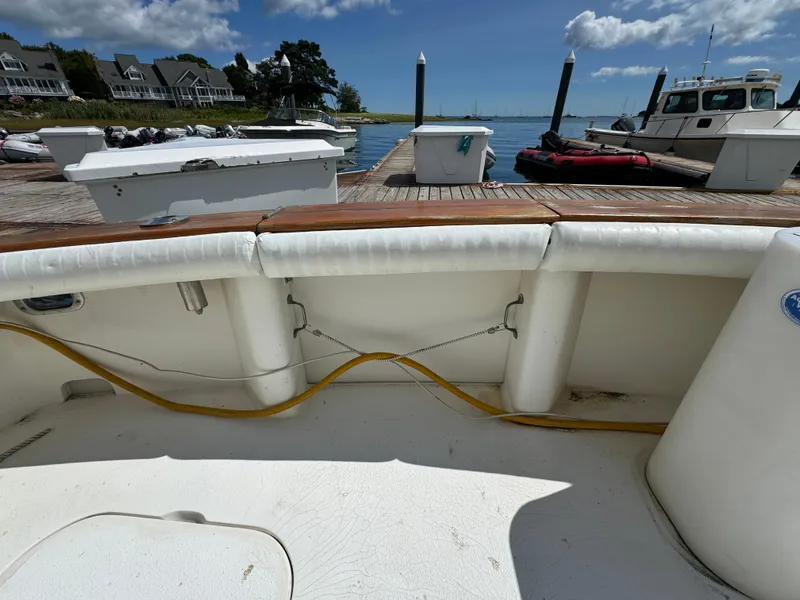Slide: The Image of 1990 Post 44 Sport Fisherman boat docked at marina with scenic waterfront view. - 8