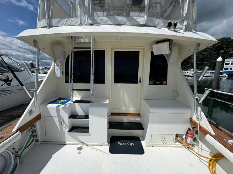 Slide: The Image of 1990 Post 44 Sport Fisherman boat deck with seating and equipment, docked at marina. - 9