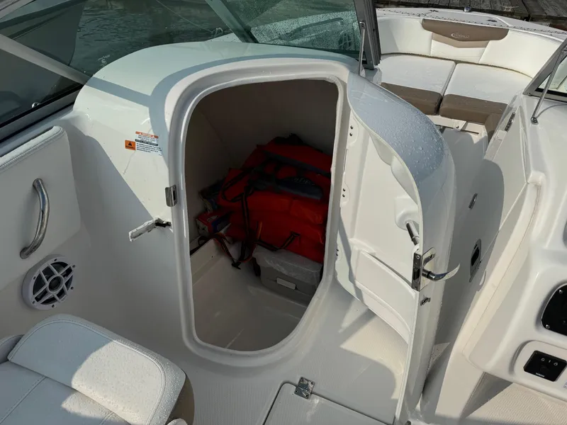 Slide: The Image of 2022 Robalo R207 Dual Console boat storage compartment with life jackets. - 11