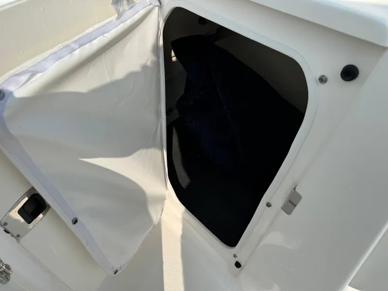 Slide: The Image of Open storage compartment on 2022 Robalo R207 Dual Console boat. - 12