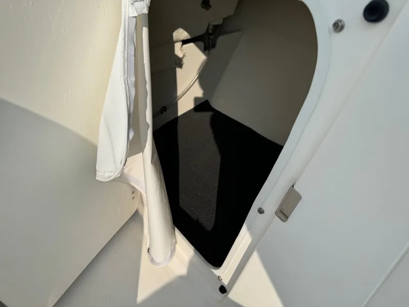 Slide: The Image of 2022 Robalo R207 Dual Console storage compartment interior. - 15