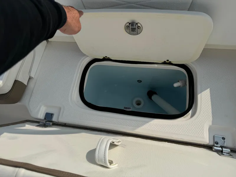 Slide: The Image of 2022 Robalo R207 Dual Console livewell compartment with open lid. - 16