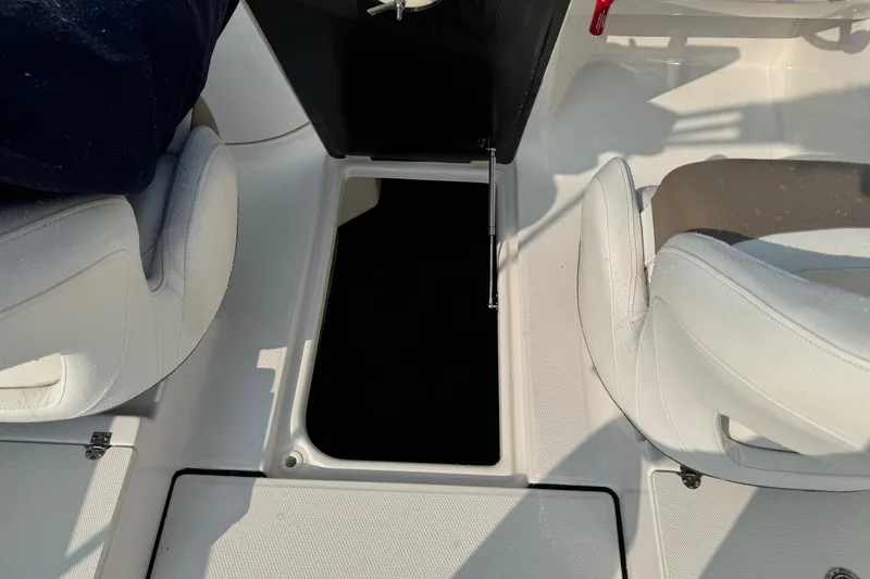 Slide: The Image of 2022 Robalo R207 Dual Console interior with open storage compartment. - 18