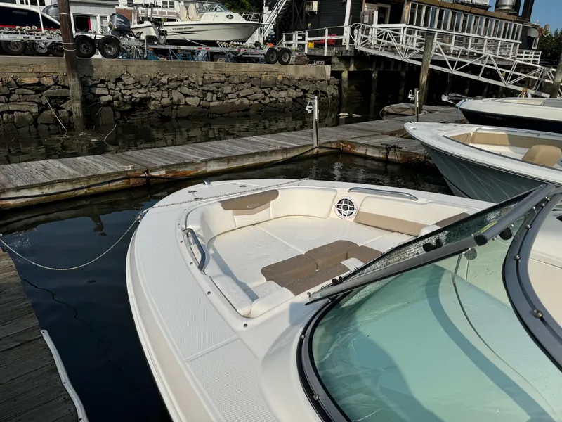 Slide: The Image of 2022 Robalo R207 Dual Console boat docked at marina. - 2