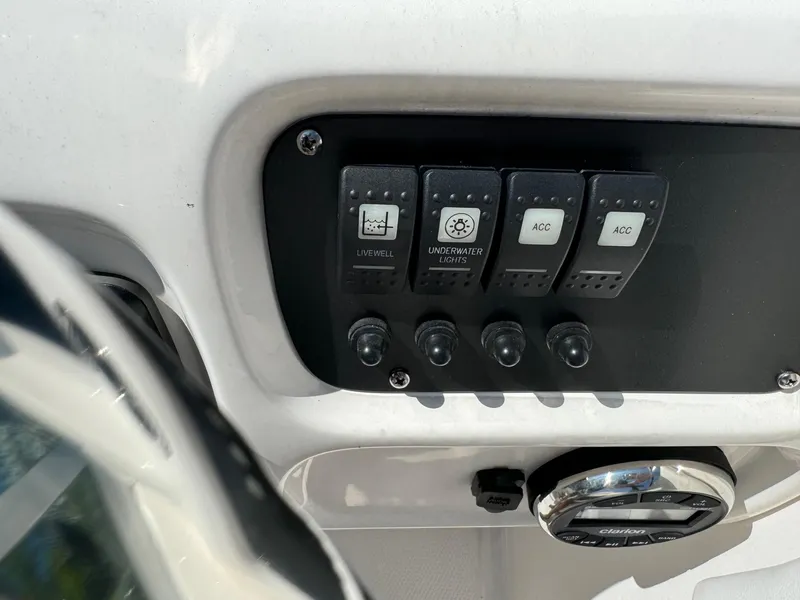 Slide: The Image of Control panel of 2022 Robalo R207 Dual Console boat with switches and dials. - 23