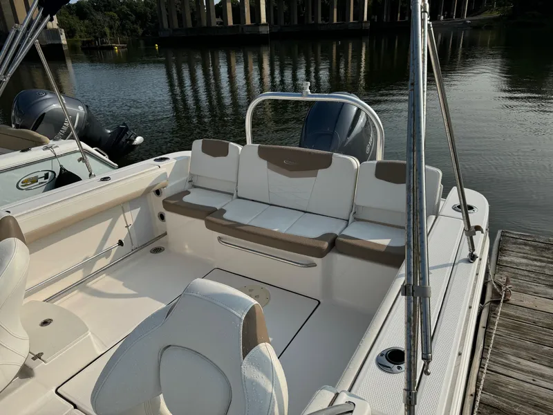 Slide: The Image of 2022 Robalo R207 Dual Console boat interior at dock, featuring comfortable seating and sleek design. - 3