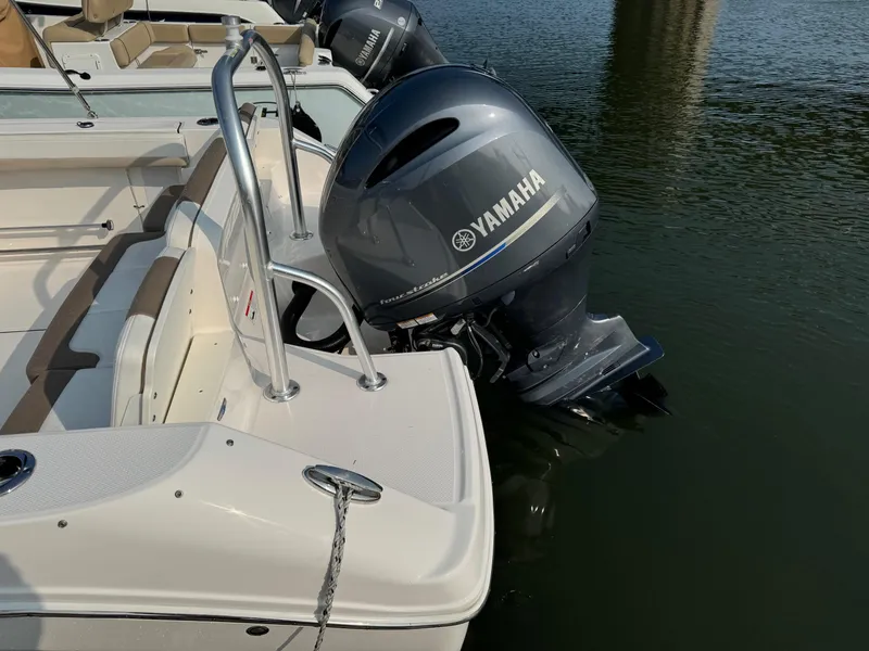 Slide: The Image of 2022 Robalo R207 Dual Console with Yamaha outboard engine on calm water. - 5