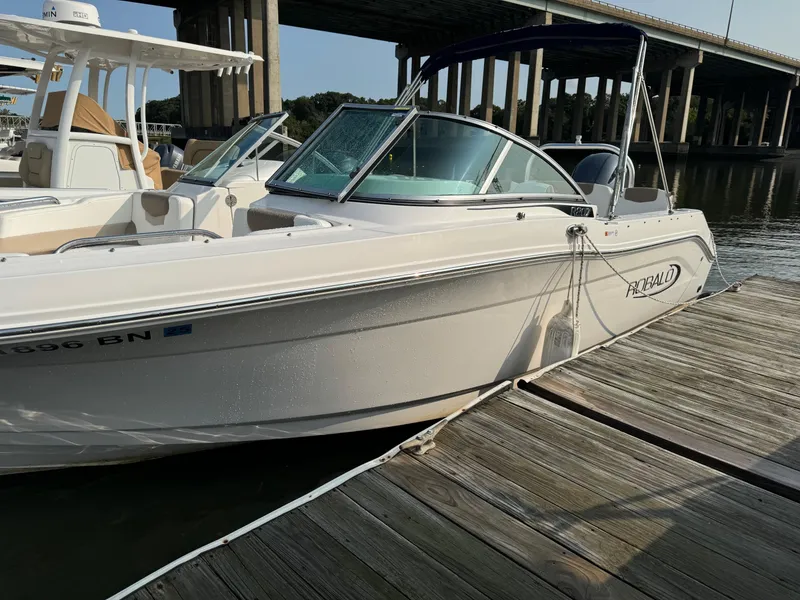 Slide: The Image of 2022 Robalo R207 Dual Console boat docked by a wooden pier. - 6