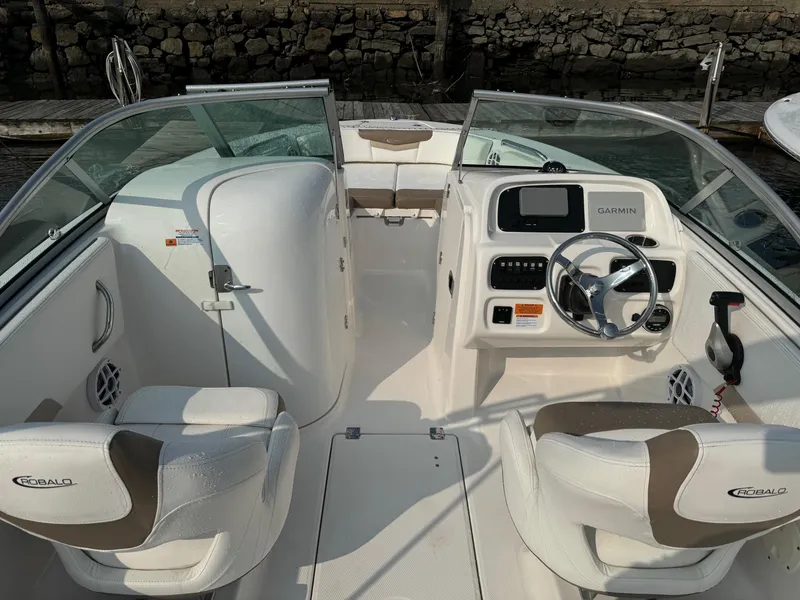 Slide: The Image of 2022 Robalo R207 Dual Console boat interior with steering wheel and seating. - 8