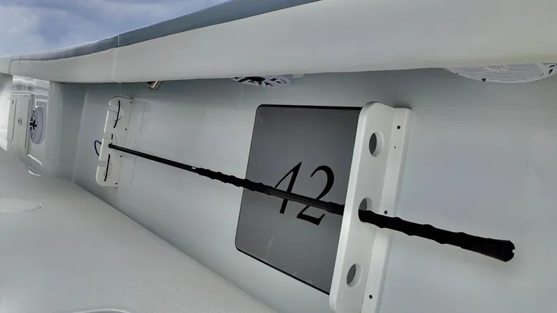 Slide: The Image of 2022 Yellowfin 42 Offshore boat interior detail with rod holder and number 42. - 11