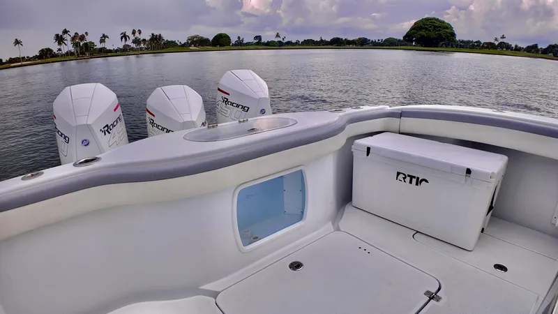 Slide: The Image of 2022 Yellowfin 42 Offshore boat with powerful engines on a serene lake. - 12