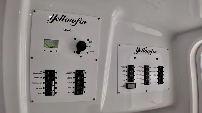 Slide: The Image of Yellowfin 42 Offshore 2022 control panels with switches and gauges. - 23