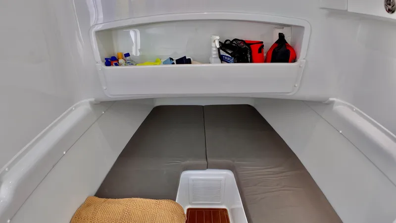 Slide: The Image of 2022 Yellowfin 42 Offshore cabin interior with storage and seating. - 25