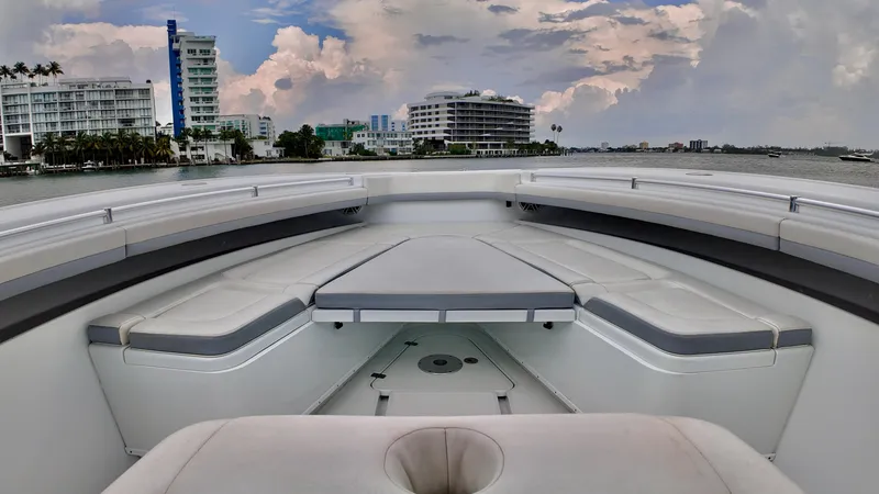 Slide: The Image of 2022 Yellowfin 42 Offshore boat with spacious seating, city skyline in background. - 3