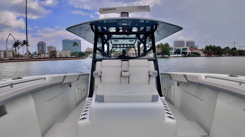 Slide: The Image of 2022 Yellowfin 42 Offshore boat on calm water with city skyline. - 4