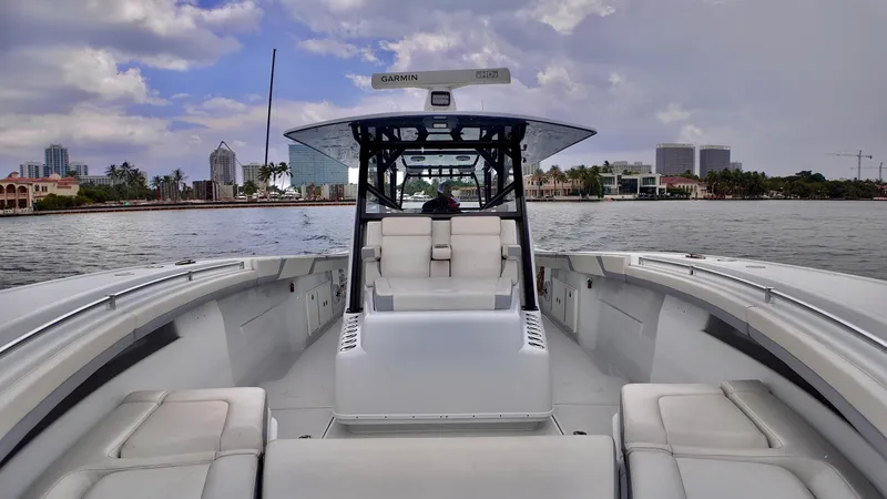 Slide: The Image of 2022 Yellowfin 42 Offshore boat on calm water, city skyline in background. - 5