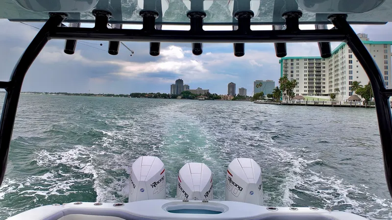 Slide: The Image of Yellowfin 42 Offshore 2022 boat cruising on water with city skyline in background. - 7