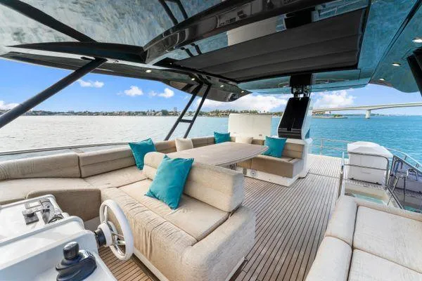 Slide: The Image of Luxurious 2018 Monte Carlo Yachts MCY 70 deck with plush seating and ocean view. - 27