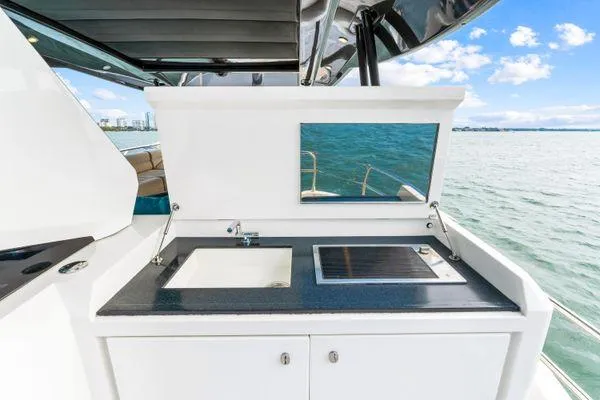 Slide: The Image of Outdoor kitchen on 2018 Monte Carlo Yachts MCY 70, featuring sink and grill. - 34