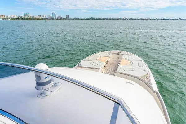 Slide: The Image of Monte Carlo Yachts MCY 70, 2018 model, cruising on calm waters with city skyline. - 36