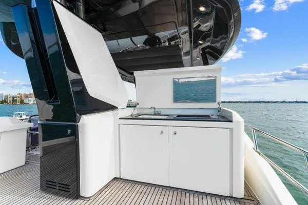 Slide: The Image of Luxury outdoor kitchen on 2018 Monte Carlo Yachts MCY 70, overlooking serene ocean view. - 33