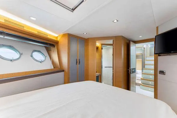 Slide: The Image of Luxurious bedroom interior of 2018 Monte Carlo Yachts MCY 70 with modern design and porthole windows. - 49