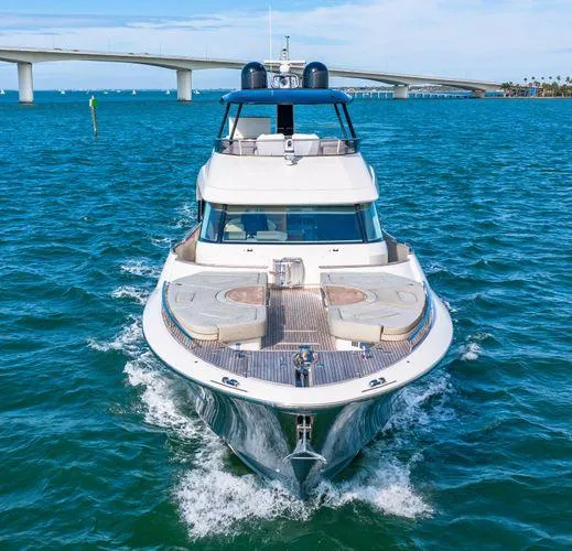 Slide: The Image of 2018 Monte Carlo Yachts MCY 70 cruising on blue waters near a bridge. - 5