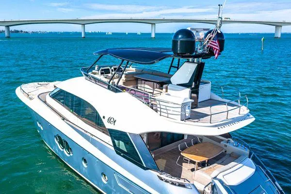 Slide: The Image of Luxurious 2018 Monte Carlo Yachts MCY 70 cruising on blue waters near a bridge. - 8