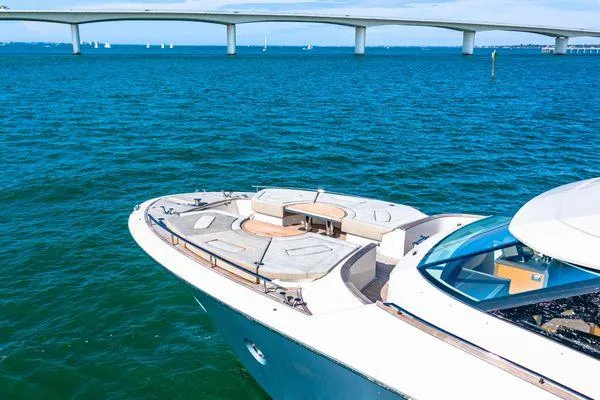Slide: The Image of Monte Carlo Yachts MCY 70, 2018 model, cruising on blue waters near a bridge. - 9