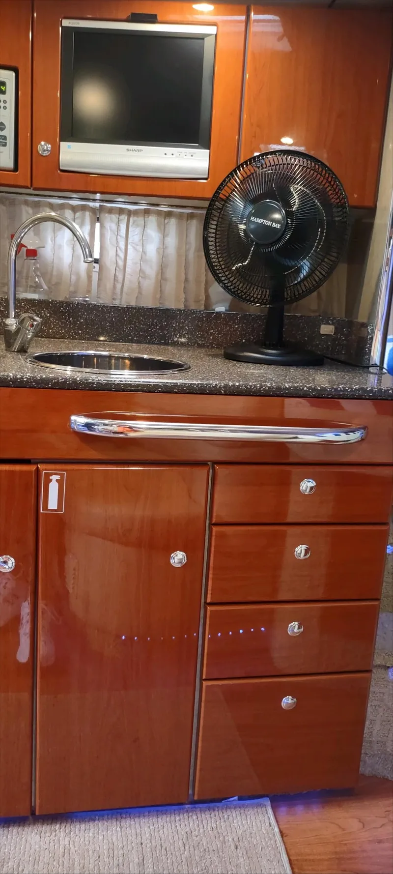 Slide: The Image of 2007 Formula 31 Cruiser kitchen area with wood cabinets, sink, and fan. - 10