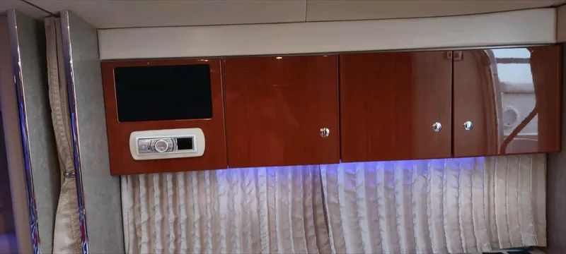 Slide: The Image of 2007 Formula 31 Cruiser interior with wood cabinets and modern entertainment system. - 13