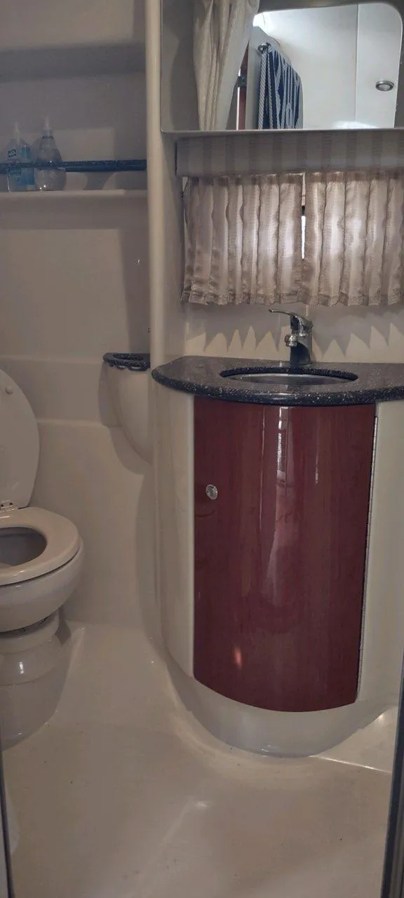 Slide: The Image of 2007 Formula 31 Cruiser bathroom with sink, toilet, and curtain. - 24