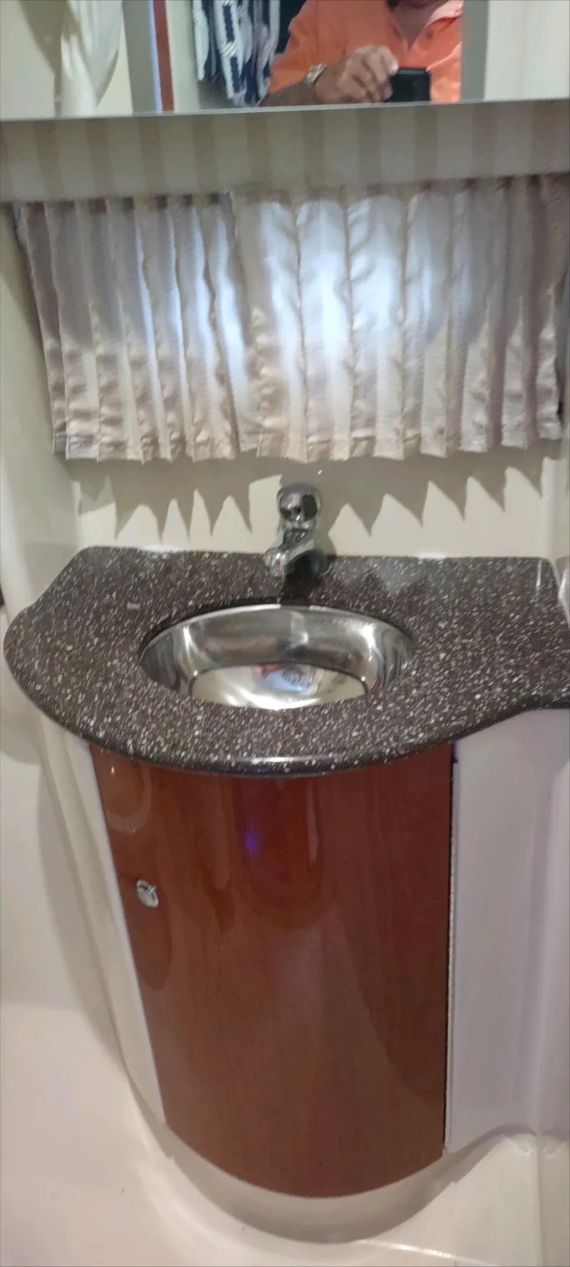 Slide: The Image of 2007 Formula 31 Cruiser bathroom sink with granite countertop and wooden cabinet. - 25