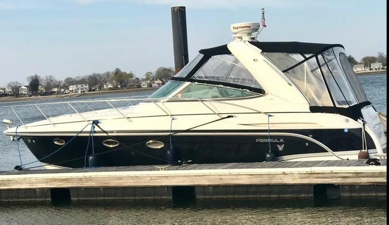 Slide: The Image of 2007 Formula 31 Cruiser docked by the water, featuring sleek design and modern amenities. - 5