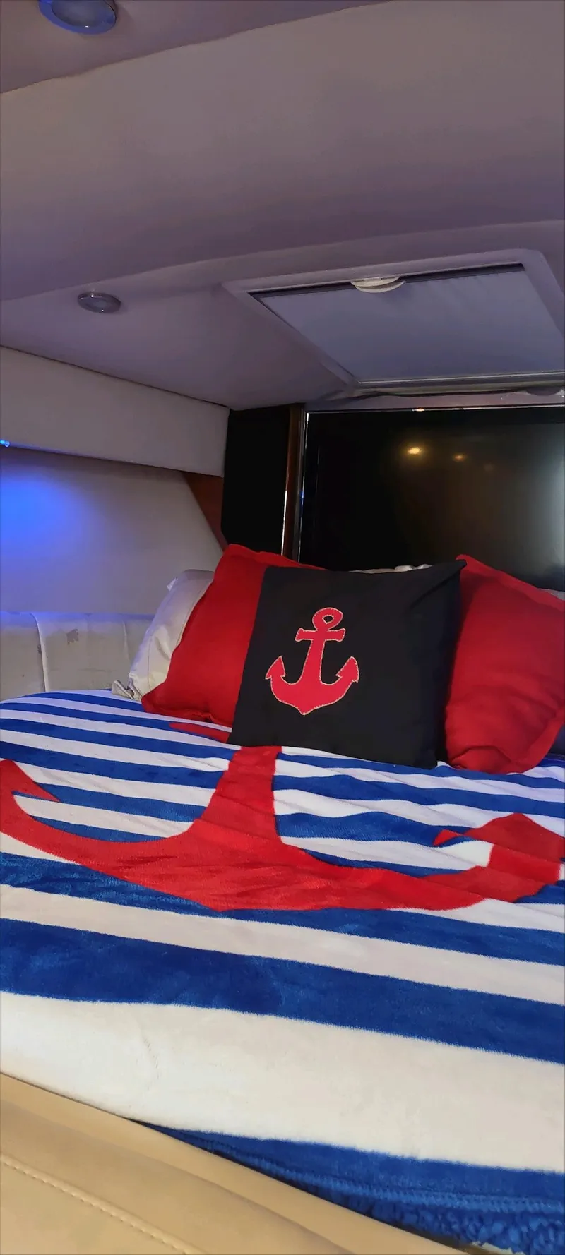 Slide: The Image of Cozy cabin interior of 2007 Formula 31 Cruiser with nautical-themed bedding. - 8