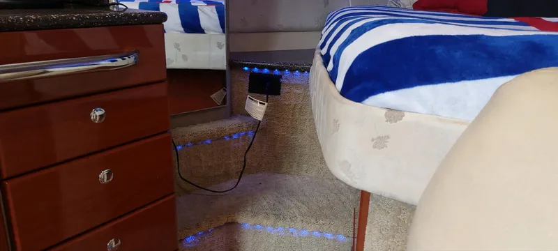 Slide: The Image of Interior of 2007 Formula 31 Cruiser with bed, steps, and wooden cabinetry. - 9