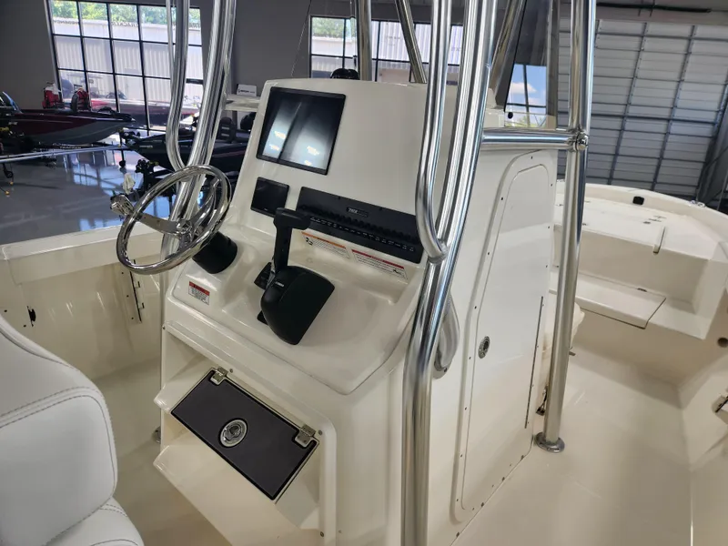 Slide: The Image of 2025 Pathfinder 2400 Open boat console with steering wheel and navigation display. - 17