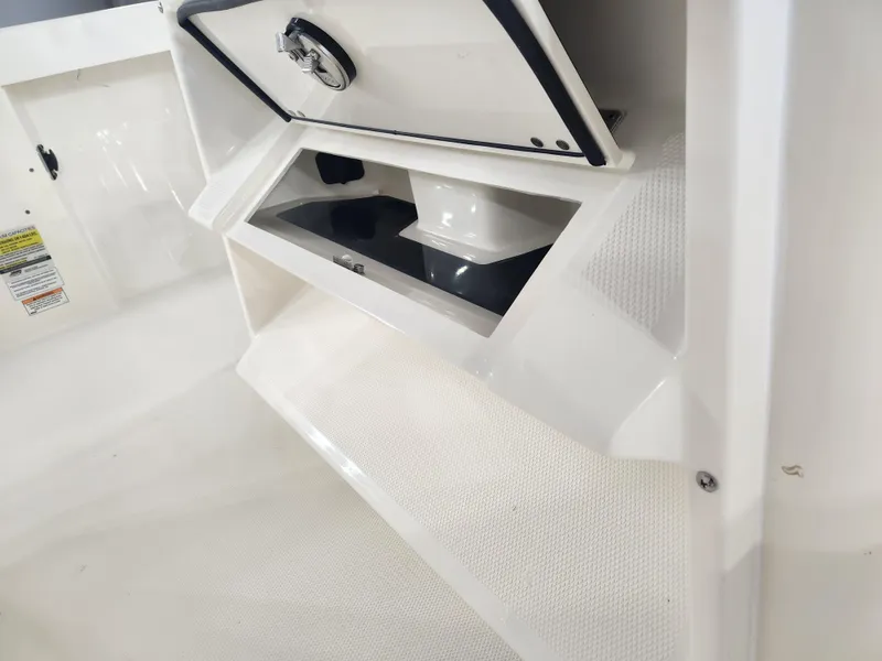 Slide: The Image of 2025 Pathfinder 2400 Open boat storage compartment with secure latch and sleek design. - 18