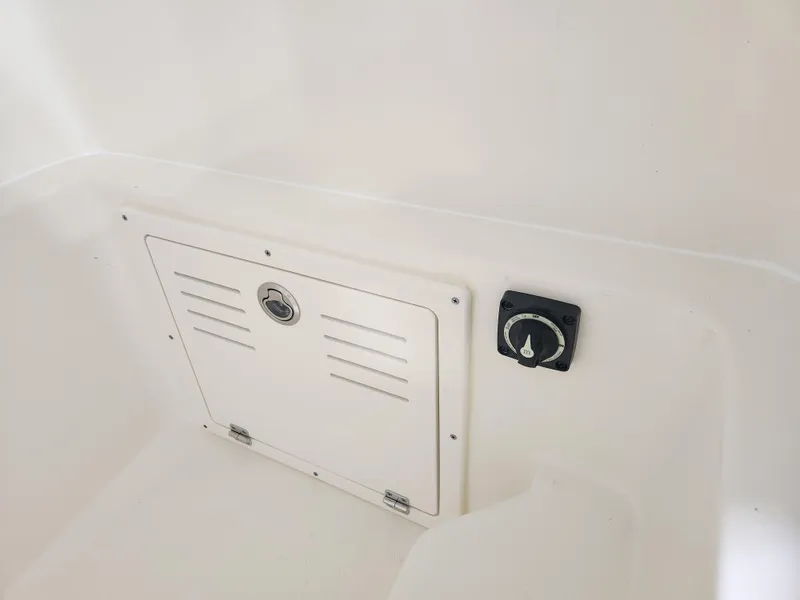 Slide: The Image of 2025 Pathfinder 2400 Open boat interior compartment and control panel. - 20