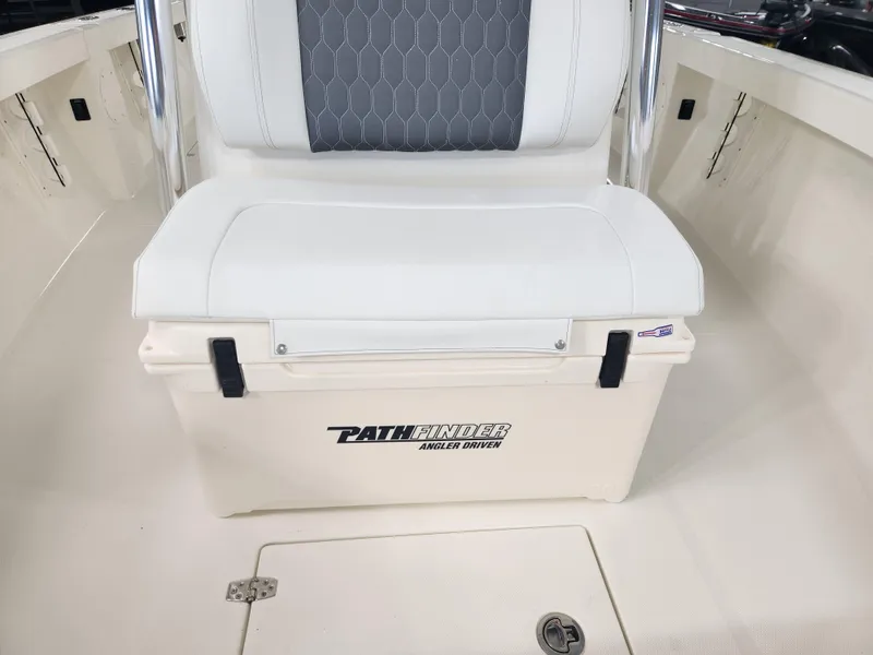 Slide: The Image of Pathfinder 2400 Open 2025 boat seat with storage compartment, featuring white and gray upholstery. - 22