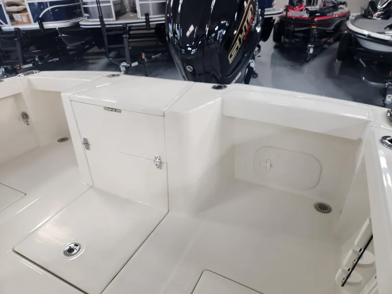 Slide: The Image of 2025 Pathfinder 2400 Open boat interior with storage compartments and outboard motor. - 26