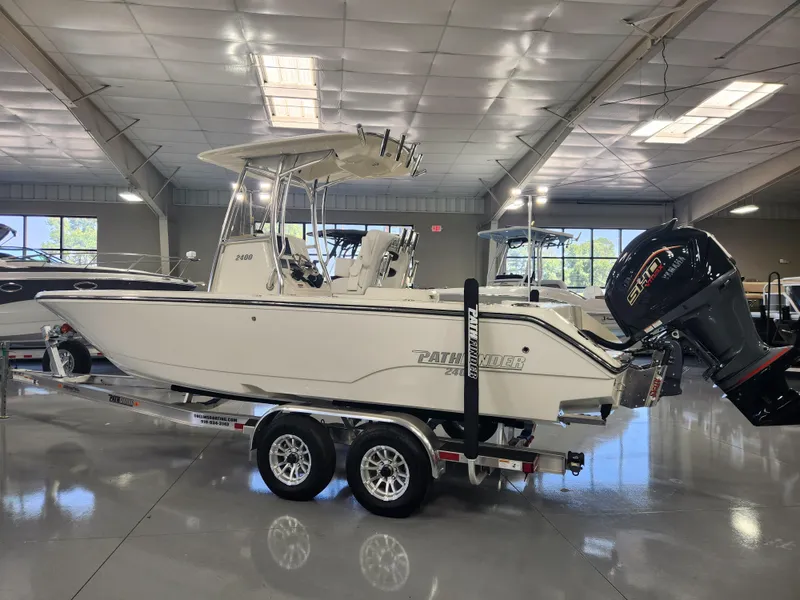Slide: The Image of 2025 Pathfinder 2400 Open boat in showroom, side view, on trailer. - 7